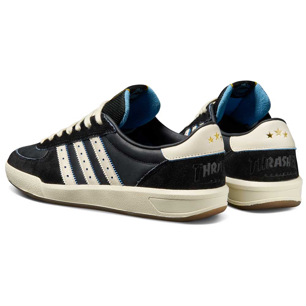 The Thrasher Magazine Glenburn Black Blue KH7384 Adidas Skateboarding Shoes feature a skate style, black and white design with three stripes, blue lining, cream heel tabs with two gold stars, and "THRASHER" text on the heel.