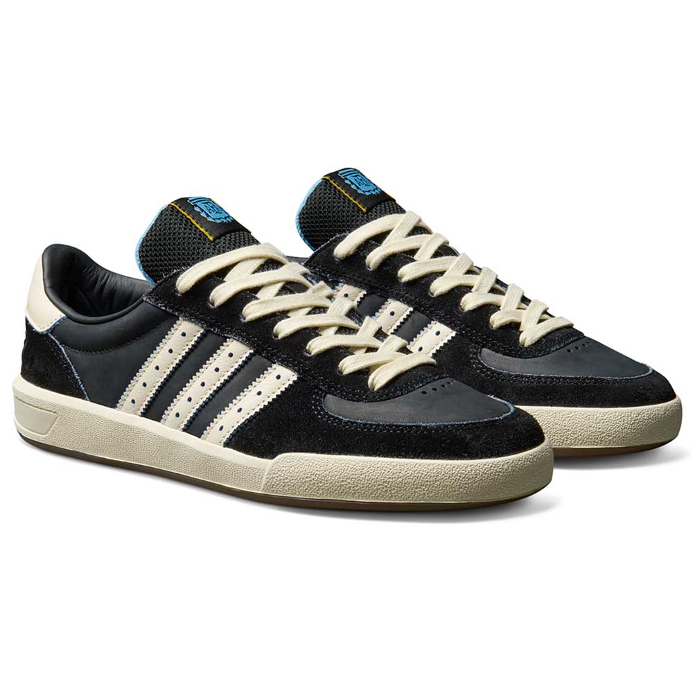 A pair of Thrasher Magazine Glenburn Black Blue KH7384 Adidas Skateboarding Shoes with black leather uppers, cream soles and stripes, cream laces, blue tongue tags, displayed side by side on a white background.