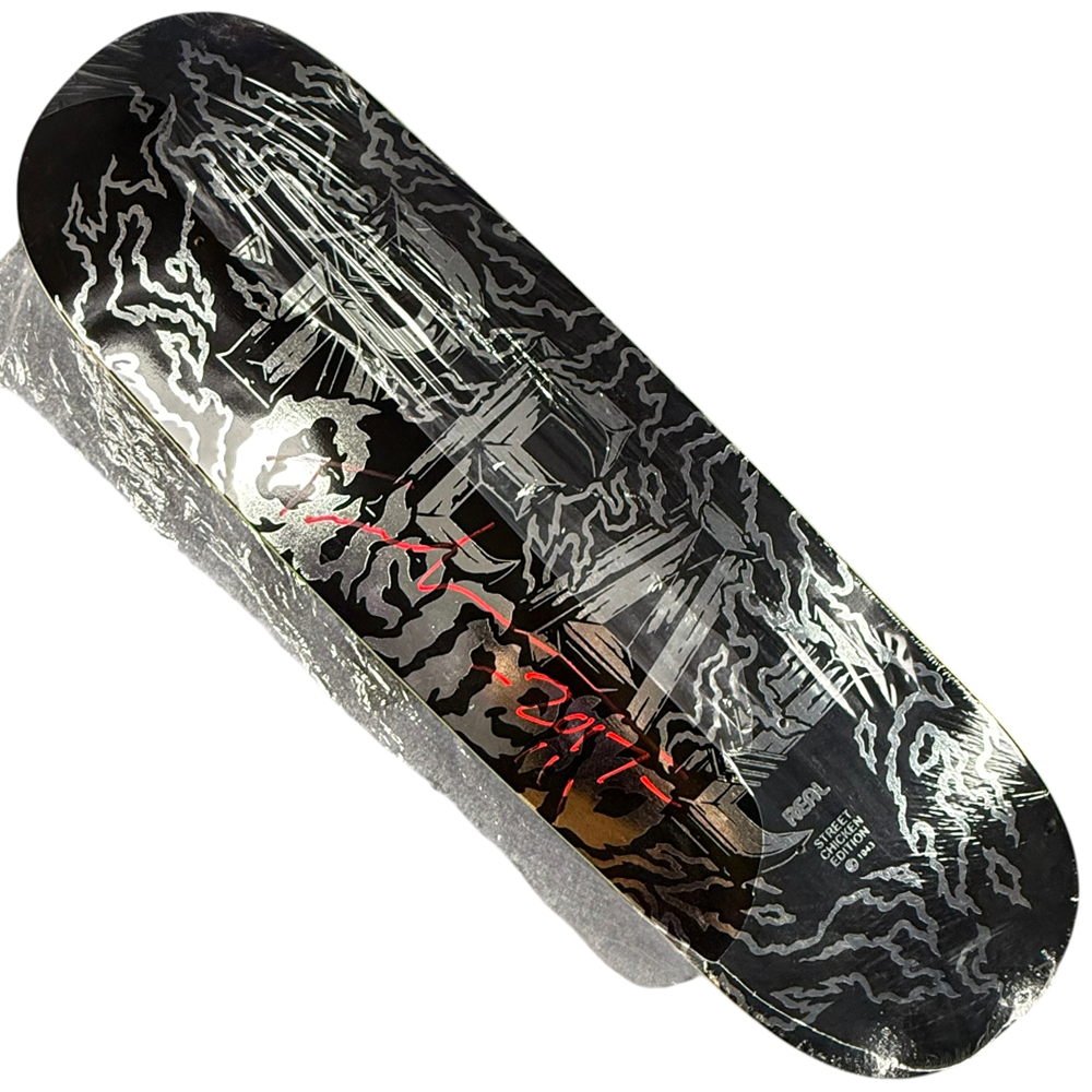 The Tommy Guerrero Silver Black Real Skateboards Deck 9x31.4 Circa 2017 is a signed collectible featuring abstract silver lines, red handwritten text at the center, and a metallic reflective finish.