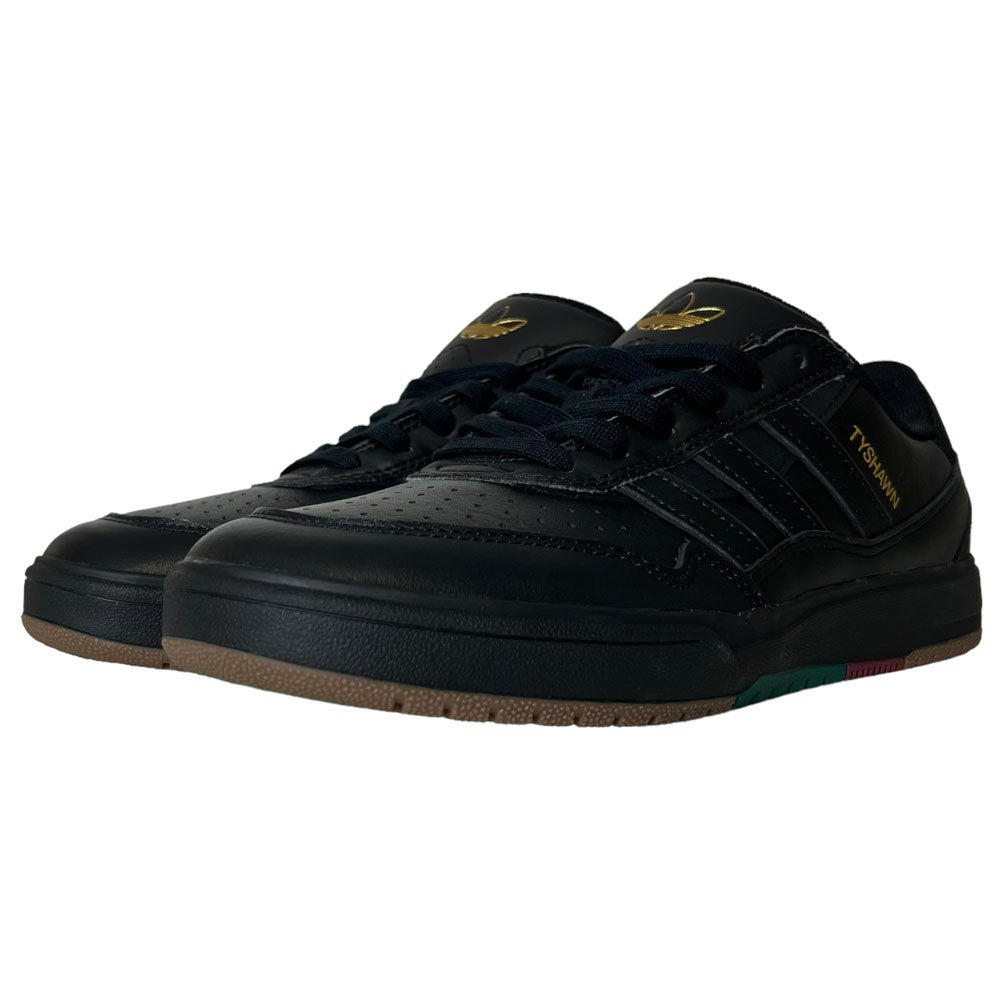 A pair of Tyshawn 2 II Adidas Skateboarding Core Black/Core Green leather shoes with gold branding, black laces, and a gum-black sole, displayed side by side on white—premium sneakers from the Adidas Skateboarding collection.