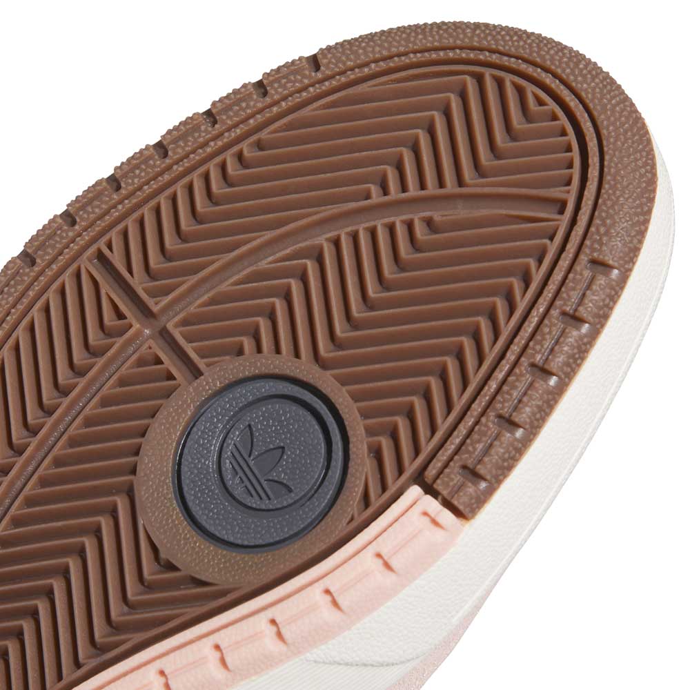 Close-up of the sole on the Tyshawn 2 II Pink Green HQ4733 Adidas Skateboarding Shoes, showing a brown herringbone rubber tread with a central trefoil logo. The sole's side is white and pale pink.
