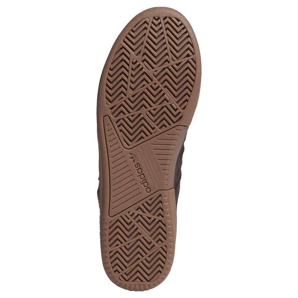 Close-up of the brown rubber sole on Tyshawn HQ4740 Brown Gum Adidas Skateboarding Suede Shoes, featuring textured zigzag and linear treads for grip. The embossed Adidas logo accents the arch—ideal for skate performance.