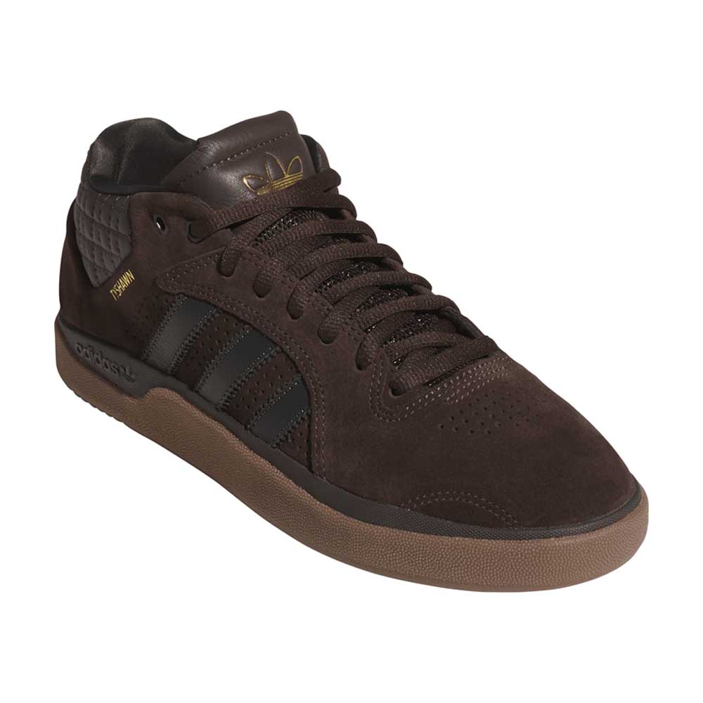 The Tyshawn HQ4740 Brown Gum Adidas Skateboarding Suede Shoes feature black stripes, a gold Adidas logo on the tongue, gold Tyshawn text on the side, a gum sole, padded textured heel, and premium suede upper for style and durability.