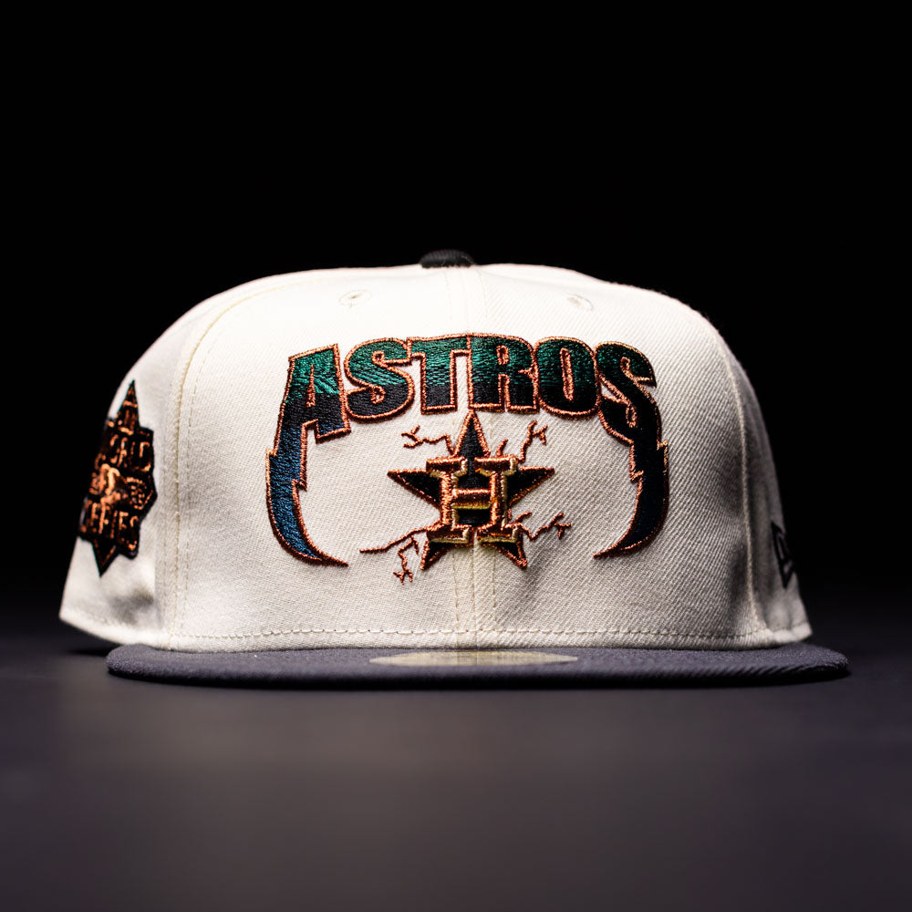 The Undaground 22WS Chrome Houston Astros New Era Hat 5950 Fitted is a white fitted cap featuring bold ASTROS text, a star logo, and decorative stitching on the front. It has a black brim, a Chrome Undaground patch detail on the side, and is displayed against a dark background.