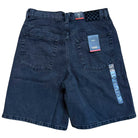 The VN000C9VEMQ1 Skate Check 5 Loose Shorts in washed black denim from Vans, shown from the back, feature two back pockets and several tags, including a checkerboard tag and a Vans logo tag.