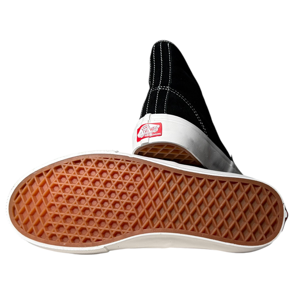 The VN000CBQS471 Authentic High Black Vans Skate Suede Rubber Shoes—one upright showing the red Vans Off The Wall logo, the other flipped to reveal its brown waffle-pattern sole—highlight their renowned skateboarding durability.