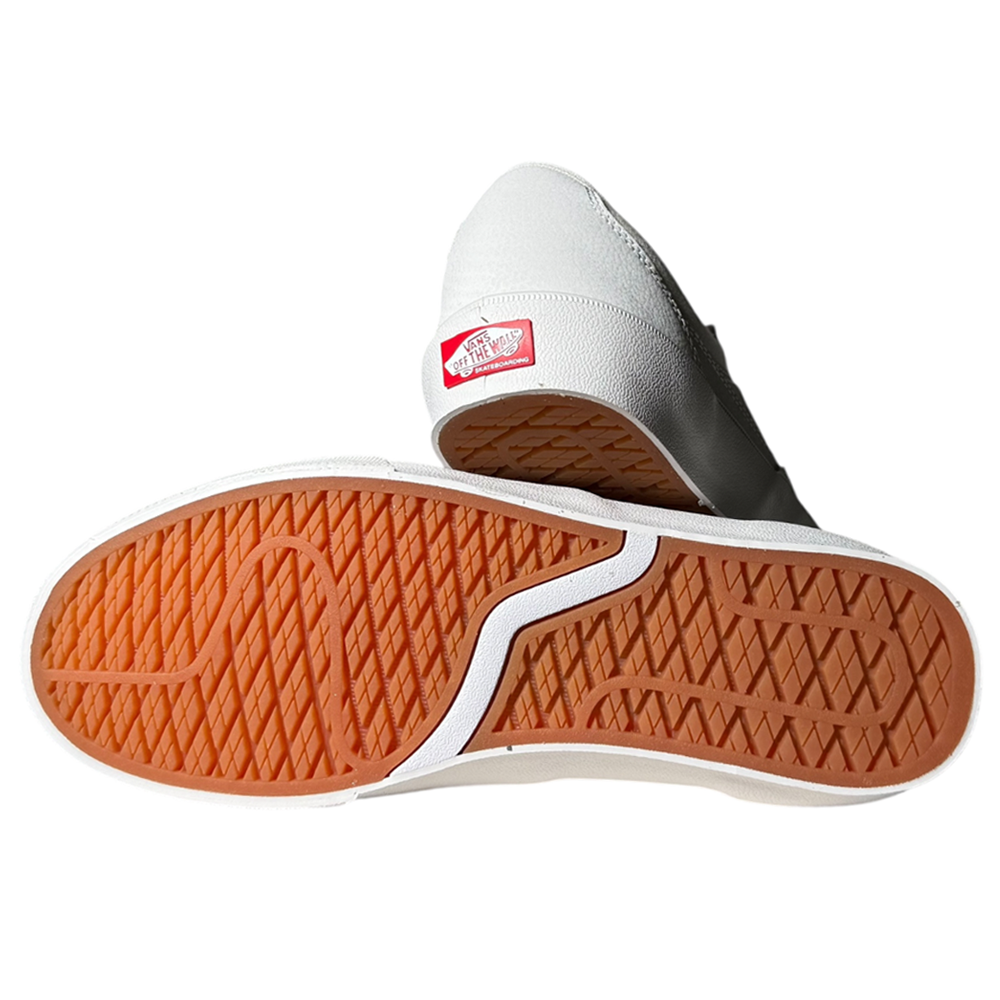 A pair of VN000D85JVY1 Skate Curren Caples Blanc de Blanc Vans skate suede rubber shoes—one highlights the orange and white wavy-tread sole, while the other shows the red Vans logo on the back heel.