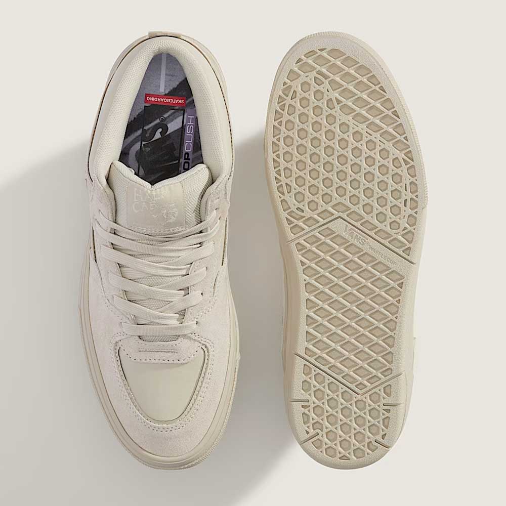 The VN000D9Z2N1 Atiba Oatmeal Suede Skate Wafflecup Half Cab Vans Shoes are shown from above—one displaying the top view with white laces and subtle stitching, the other the textured sole with a Wafflecup hexagonal pattern.