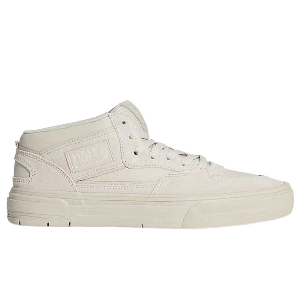 The VN000D9Z2N1 Atiba Oatmeal Suede Skate Wafflecup Half Cab Vans Shoes are mid-top, light beige skate shoes with a lace-up front, textured Wafflecup sole, subtle stitching, and a rectangular embossed-branded side patch.