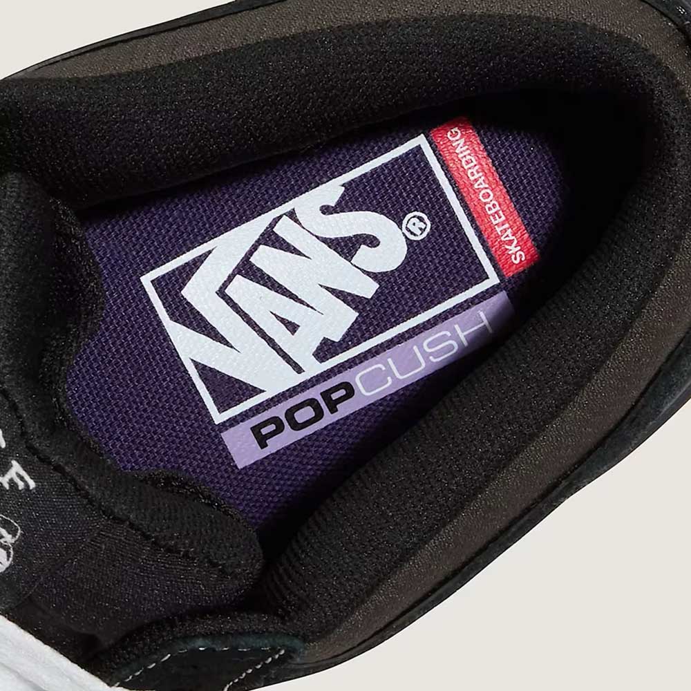 Close-up of the VN000D9ZKOU Black Asphalt Suede Skate Wafflecup Half Cab Vans Shoes shows a purple insole with white Vans and PopCush logos, plus a red Skateboarding label—emphasizing Wafflecup comfort.