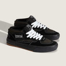 The VN000D9ZKOU Black Asphalt Suede Skate Wafflecup Half Cab Vans Shoes feature white laces and stitching, a "Half Cab" side label, and a black Wafflecup sole, shown against a light beige background.