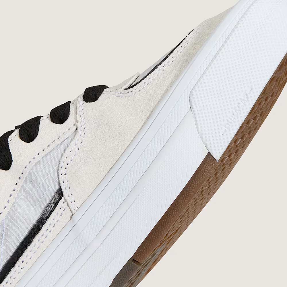 A close-up of the VN000D9ZYB2 White Black Suede Skate Wafflecup Half Cab Vans Shoes features black laces, a translucent side panel, and a textured white Wafflecup sole, highlighting the shoe's side and sole against a plain background.