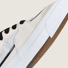 A close-up of the VN000D9ZYB2 White Black Suede Skate Wafflecup Half Cab Vans Shoes features black laces, a translucent side panel, and a textured white Wafflecup sole, highlighting the shoe's side and sole against a plain background.