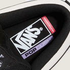 Close-up of the VN000D9ZYB2 White Black Suede Skate Wafflecup Half Cab Vans shoe insole, showing the bold white Vans logo, a purple POP CUSH label, a red SKATEBOARDING tag, and signature Wafflecup construction.