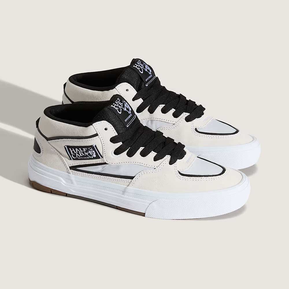 The VN000D9ZYB2 White Black Suede Skate Wafflecup Half Cab Vans shoes feature black laces, black logo patches on the tongue and side, and a white Wafflecup rubber sole, showcased against a neutral background.