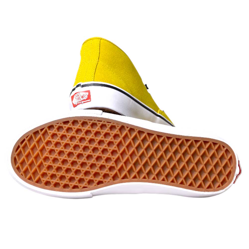 A pair of VN000EEEEMX1 Mustard Authentic Mid Vans Skate Suede Shoes—one upright, the other flipped to show its signature waffle-patterned brown rubber sole.