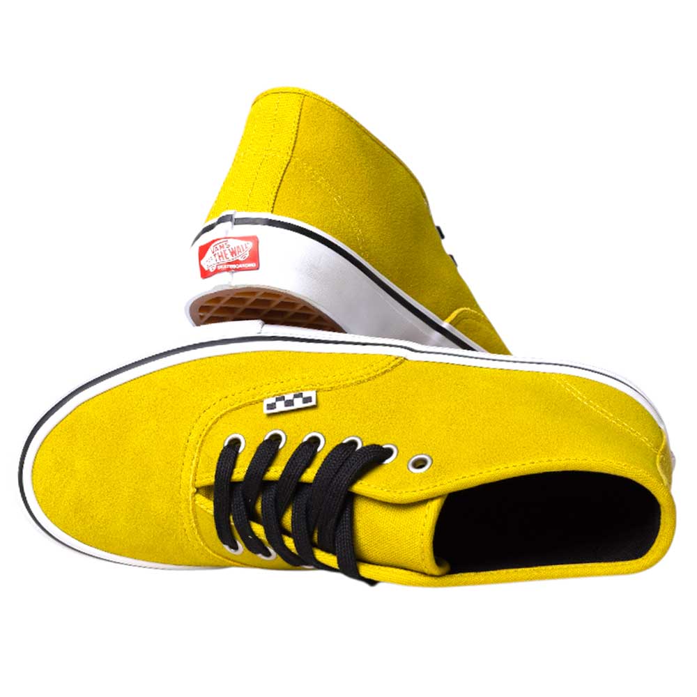The VN000EEEEMX1 Mustard Authentic Mid Vans Skate Suede Shoes feature white soles and black laces, with one shoe on its side showing the classic waffle-patterned sole and the other standing upright.
