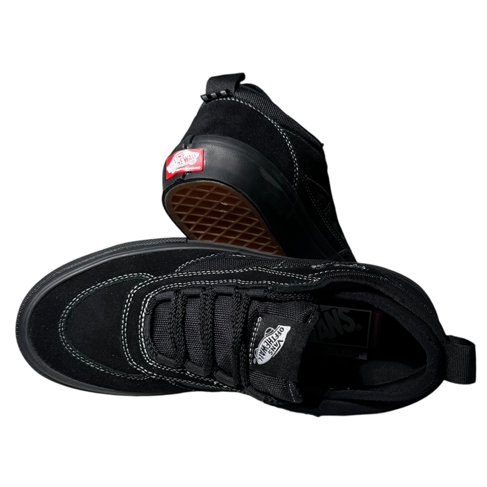 The VN000EEHBKA1 Skate Safe Low Black Vans Skate Suede Rubber Shoes feature white stitching, a durable waffle-patterned sole, one shoe flat, one tilted, and the signature red Vans logo on the heel.