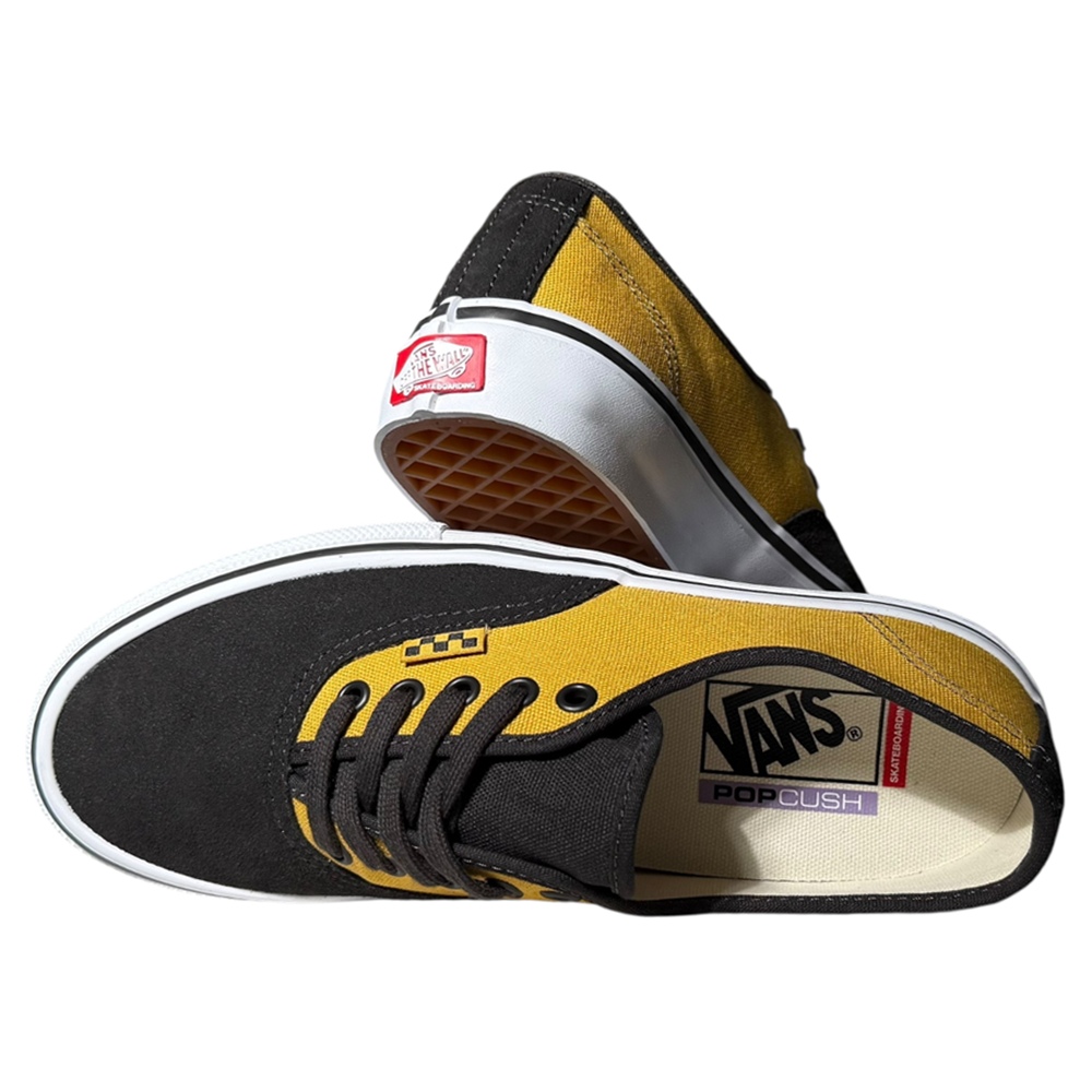 A pair of VN000EERBLN Fade Brown Mustard Authentic Vans Skate Suede Shoes featuring black and yellow canvas uppers, black laces, white midsoles, and Vans logos on the insole and heel. One shoe is upright, the other shows the sole.