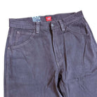 The VN000KXMY7U Skate Check 5 Loose After Dark Denim Vans Pant features dark gray heavyweight denim with white stitching, belt loops, front pockets, and a red waistband label—ideal for fans of loose-fit denim.