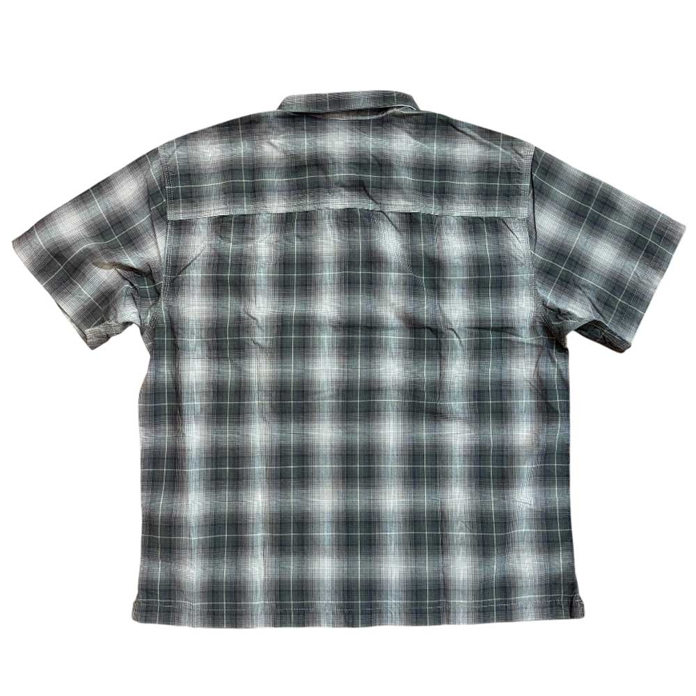 The VN000KYW1NU1 Walnut Skate Plaid SS Woven Top from Vans is a short-sleeved, button-up shirt in black, gray, and white plaid, displayed flat with the back facing up.