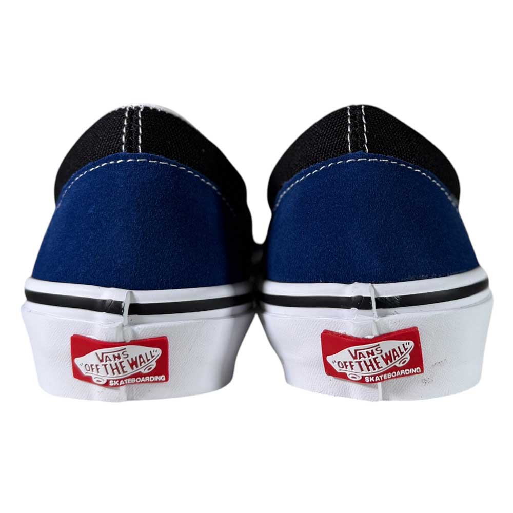 Rear view of VN0A2Z31Y40 Sport Blue Black Skate Slip On Vans Suede Shoes with blue/black uppers, white midsoles, and red Off The Wall heel logos. Classic style and comfort ideal for skate shoe fans.