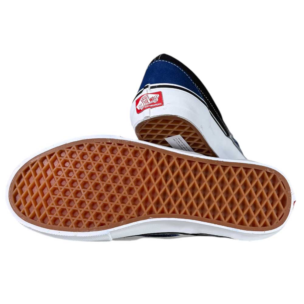 A pair of VN0A2Z31Y40 Sport Blue Black Skate Slip On Vans Suede Shoes, featuring one shoe’s waffle-patterned brown sole and the other’s red Vans Off The Wall heel logo.
