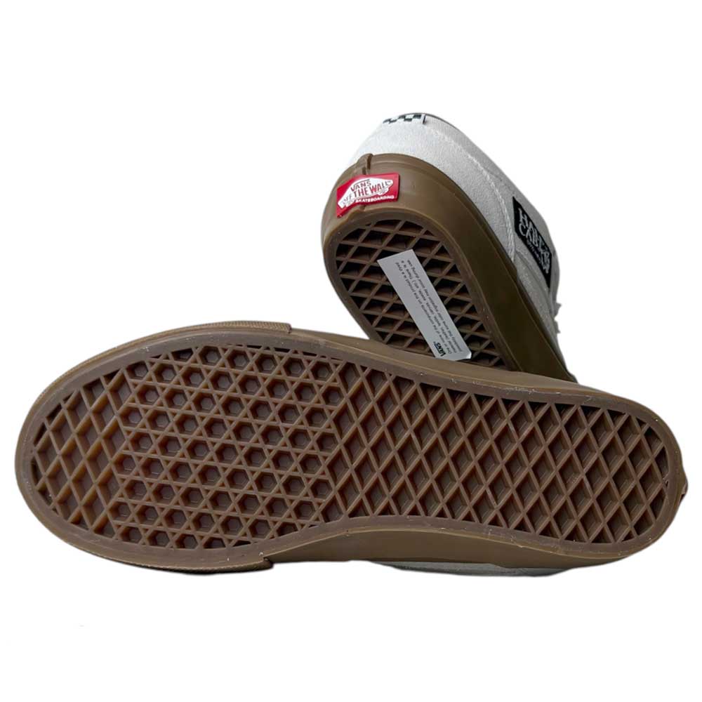 The VN0A2Z348YG Antique White Gum Suede Skate Half Cab Vans Shoes—one shown on its side to reveal the brown waffle sole, the other upright displaying the red Off the Wall heel logo—blend classic Vans style with skate-ready comfort.