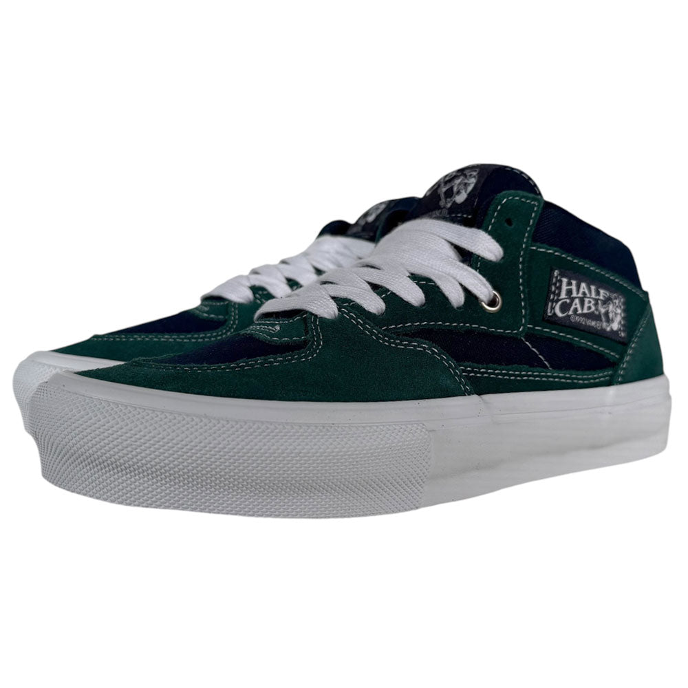 A pair of VN0A2Z34BLG Tartan Blue Green Suede Skate Half Cab Vans shoes with white laces and thick white soles, viewed from a low angle, designed for maximum comfort and support during skating.