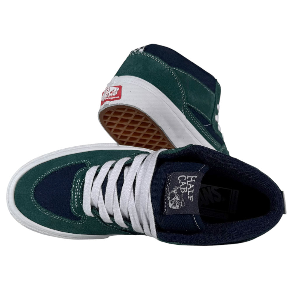 A pair of VN0A2Z34BLG Tartan Blue Green Suede Skate Half Cab Vans Shoes with PopCush footbeds, white laces, and waffle-patterned soles. One shoe stands upright; the other is on its side revealing the sole.