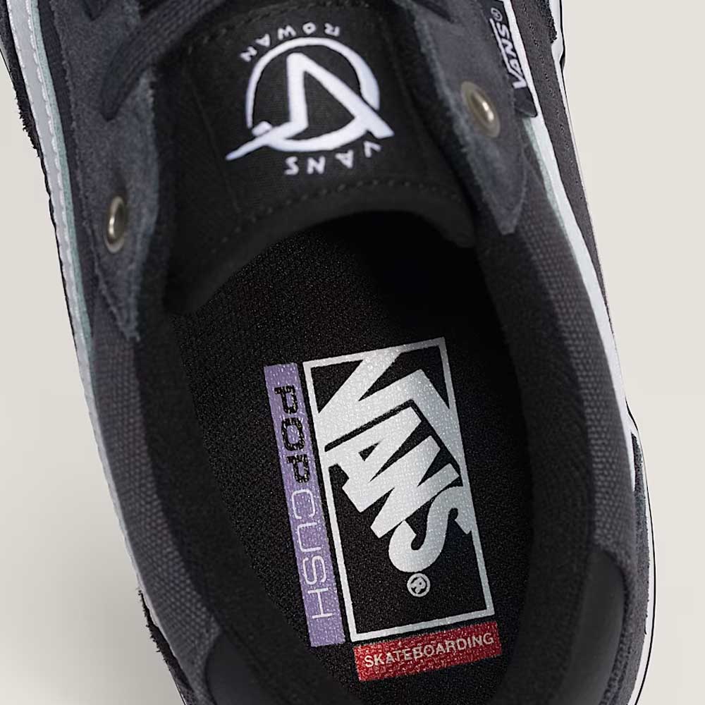 Close-up of the inside of a Vans Rowan Charcoal Gray VN0A5JICH911 suede skate shoe, highlighting the insole with Vans, PopCush, and Skateboarding text, as well as the Vans logo on the tongue. This durable skate shoe is part of the Suede Rowan Vans Shoes line.
