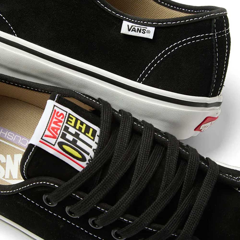 Close-up of the Vans Skate AVE Classic Black White VN000Y1NBA2 Suede Skateboard Shoes, featuring a black suede upper with white soles. The Vans logo appears on the side tag and on the tongue, which also displays the Off The Wall label. These sneakers showcase signature Wafflecup construction for superior support and are finished with black laces.