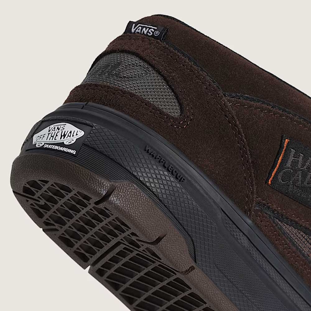 Close-up of the heel and sole of the Vans Skate Half Cab Walnut Gum VN0A5FCD77J1 suede skateboard shoes, featuring the Off the Wall logo on a black rubber sole and tags on the suede upper—designed with PopCush impact protection.