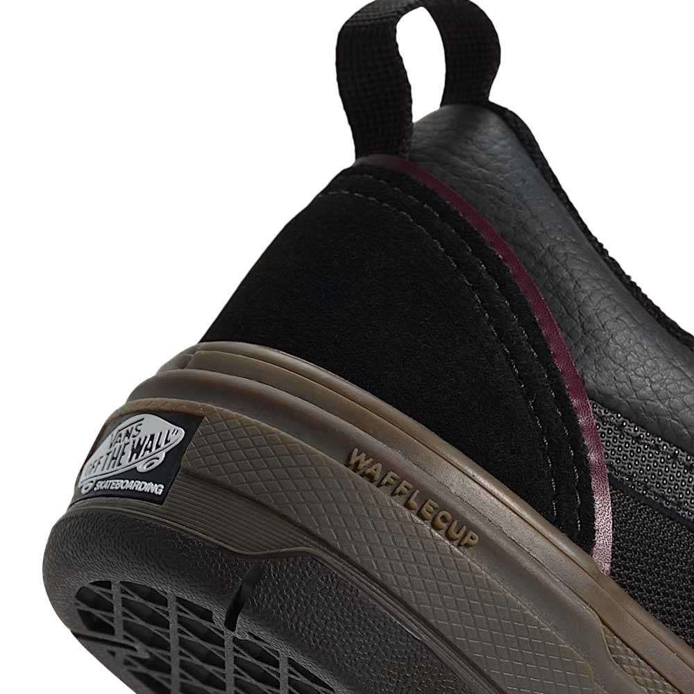 Close-up of the Vans Wafflecup Old Skool Black Dark Gum VN000EB739L1 suede skate shoe’s heel with brown sole, featuring WAFFLECUP text, a black pull tab, and a Vans Off The Wall logo on the back.