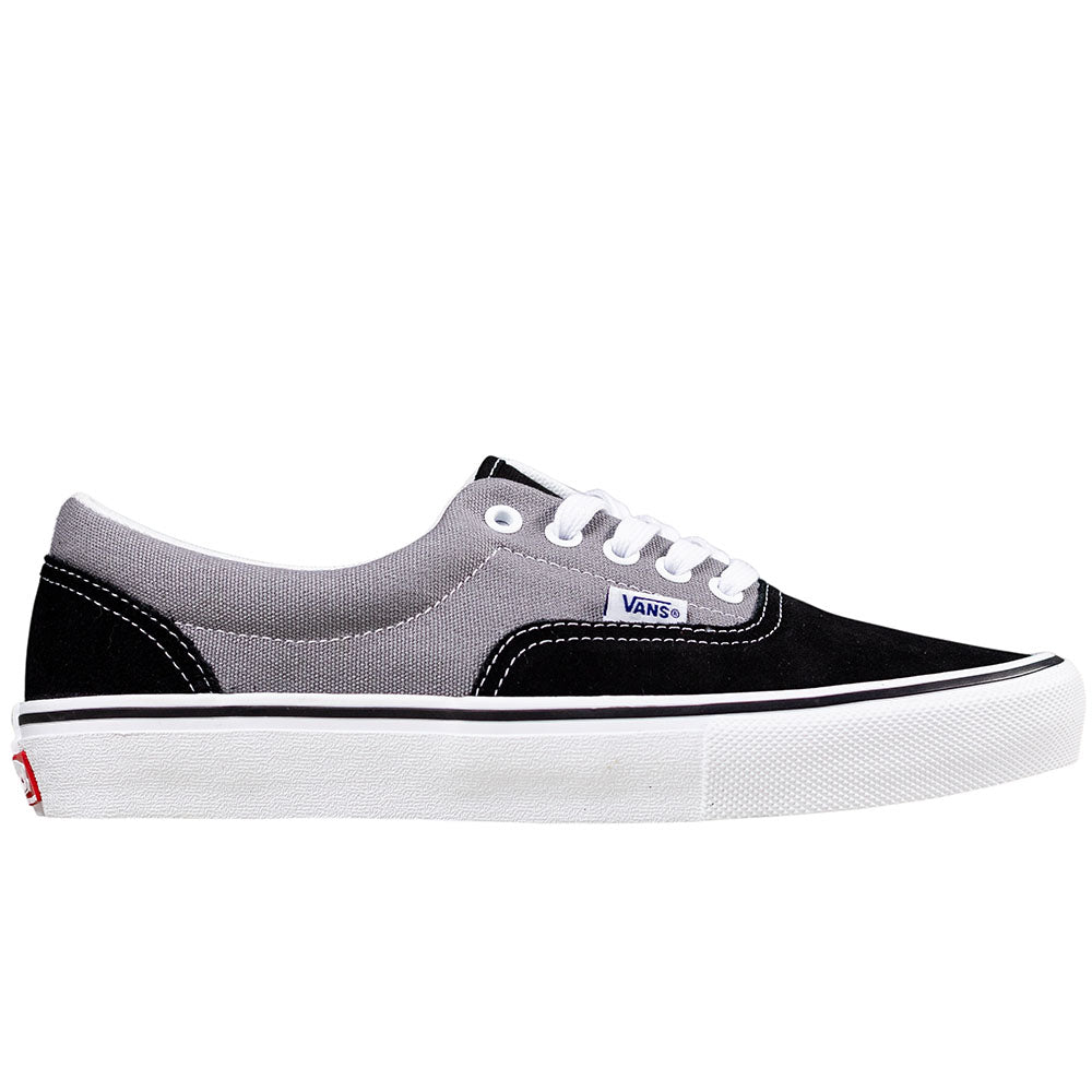 The Vans Skate Era Black Gray VN000ECRDE21 features a black and gray suede upper, white laces, durable rubber sole for grip, and a blue Vans logo tag on the side.