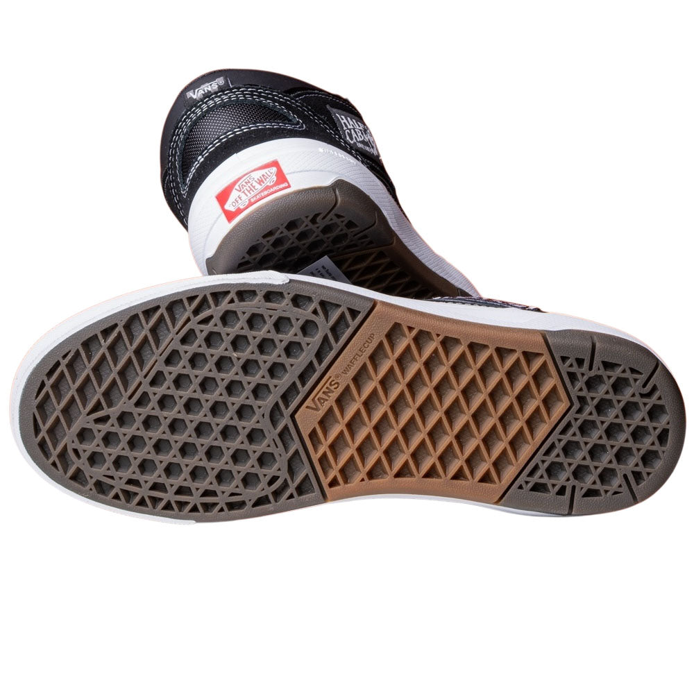 The Vans Wafflecup Half Cab Black White VN000D9ZBA2 Suede Skate Shoes feature a classic black and white look, a textured multi-colored Wafflecup sole, and the iconic red Vans logo on the heel—ideal for Half Cab fans.