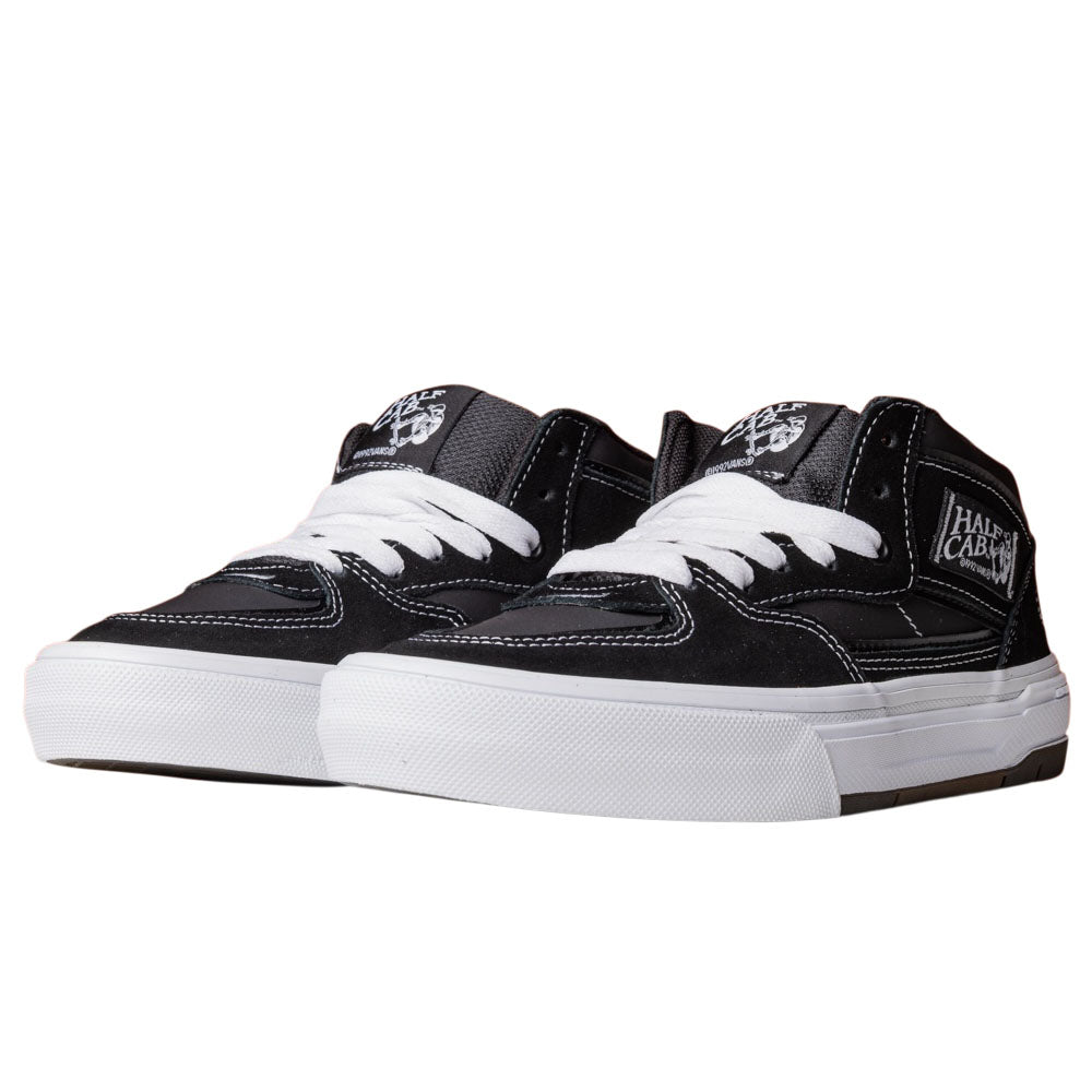The Vans Wafflecup Half Cab Black White VN000D9ZBA2 Suede Skate Shoes feature white laces, white stitching, and Wafflecup rubber soles, shown angled against a plain white background.