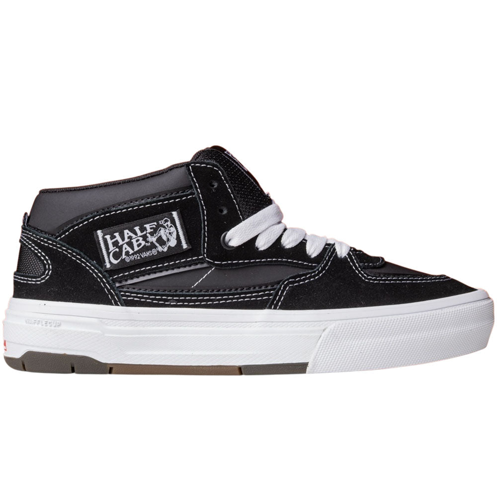 The Vans Wafflecup Half Cab Black White VN000D9ZBA2 Suede Skate Shoes feature black suede and canvas uppers, white laces, a white sole, visible stitching, Half Cab branding on the side, and Vans’ signature Wafflecup outsole for grip.