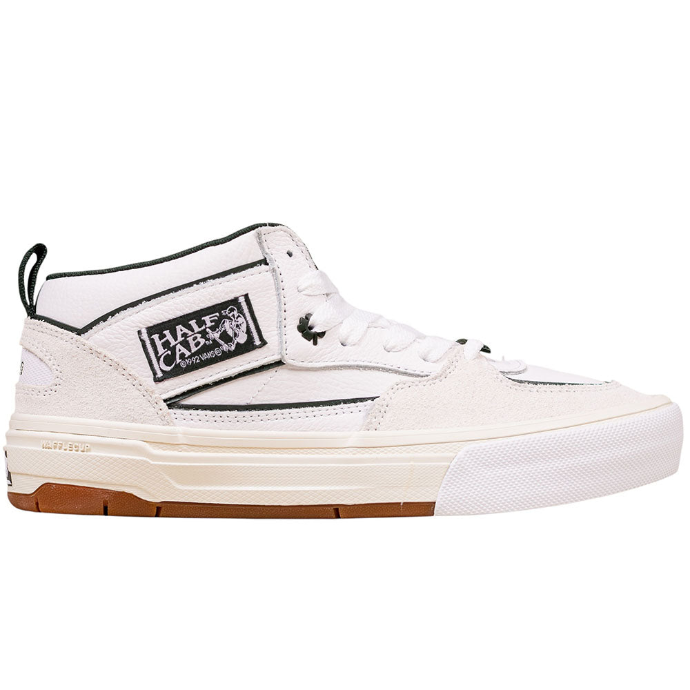 The Vans Wafflecup Half Cab Una White Gum VN000D9Z9DH1 Suede Skate Shoes feature a white and beige mid-top design with black accents, signature side patch, small graphic, white laces, and a WaffleCup™ sole with gum bottom.