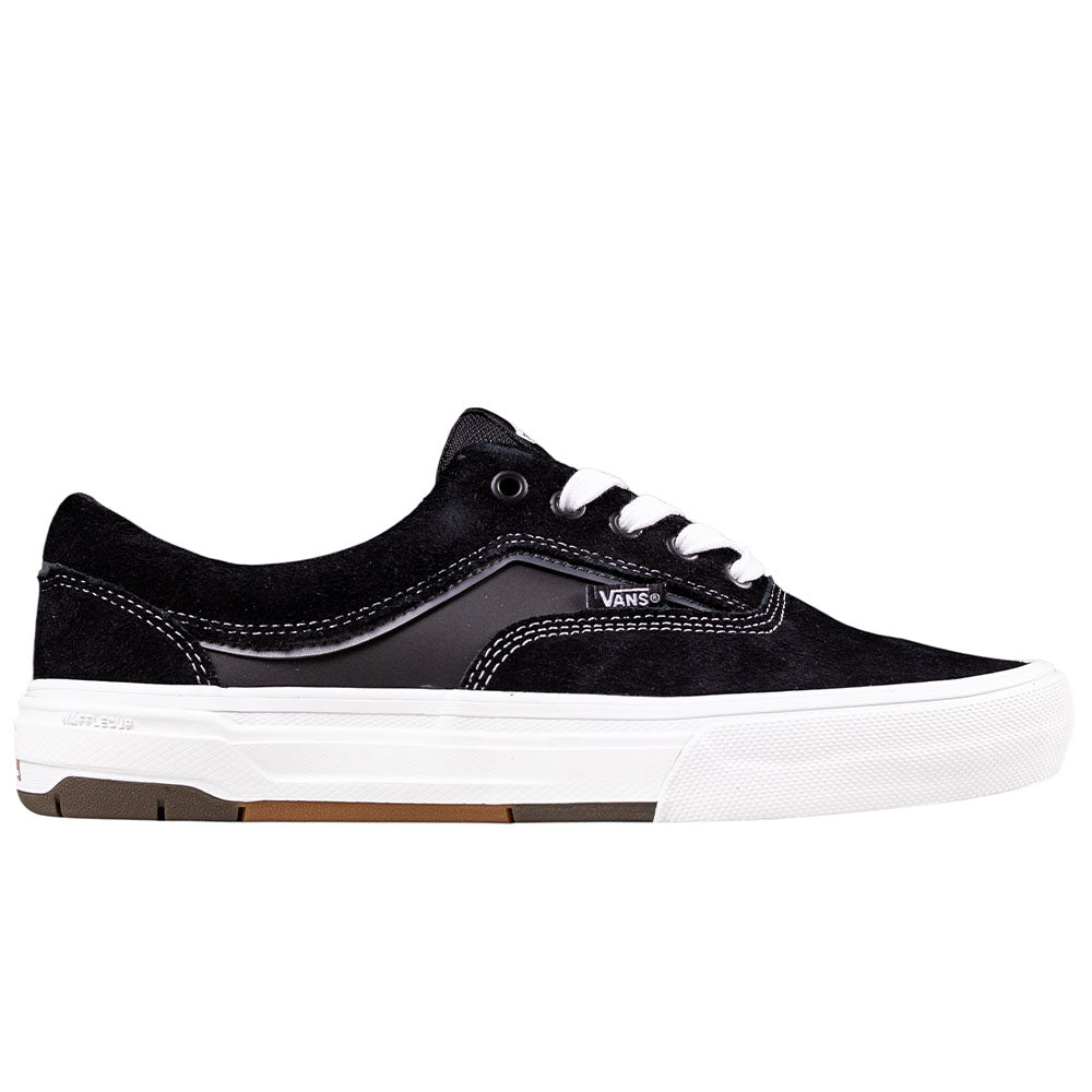 The Skate Era Wafflecup Black White VN000EF0BA21 by Vans is a low-top suede skate shoe with white stitching and laces, a thick white rubber sole, Wafflecup construction, and the Vans logo for iconic style and durability.