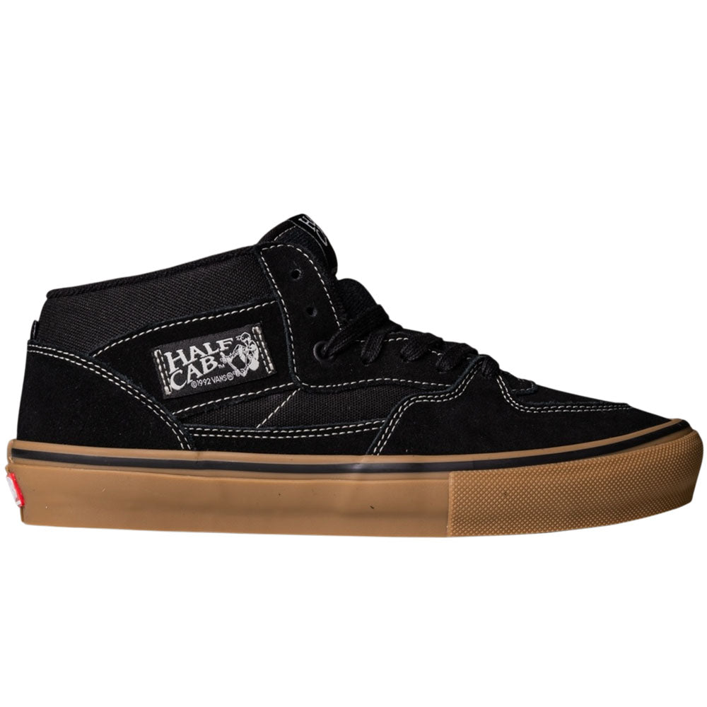 The Vans Half Cab Black Gum White VN0A5FCDB9K Suede Skate Shoes feature black suede, white stitching, a gum rubber sole, and a “Half Cab” side label. Shown in profile view facing right.
