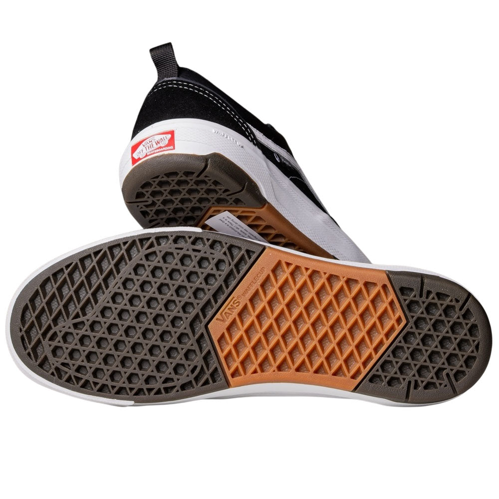 A pair of Vans Wafflecup Old Skool Black White VN000EB7BA2 suede skate shoes, one on its side and the other displaying an orange, gray, and black sole with a mix of honeycomb and waffle tread patterns.