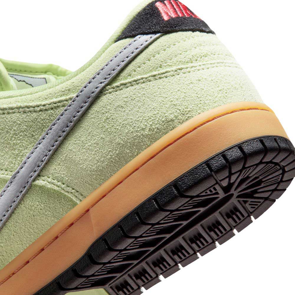 Close-up of the Verdugo Mountain Dunk Low Pro HQ1626300 Light Liquid Lime/Wolf Grey/Black Nike SB Suede Shoes—featuring a grey swoosh, black/red heel details, gum sole, and textured stitching for classic sneaker fans.