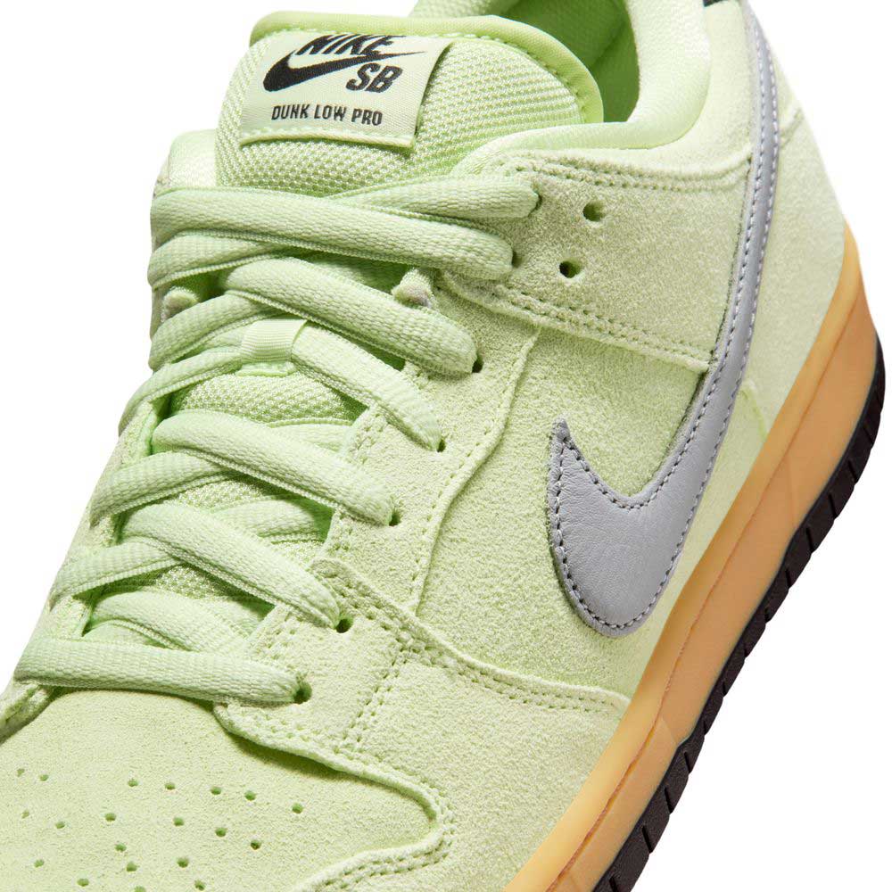 Close-up of Nike SB Verdugo Mountain Dunk Low Pro HQ1626300 in Light Liquid Lime/Wolf Grey/Black, featuring suede texture, pale blue swoosh, light green laces and tongue, and a light brown rubber sole.
