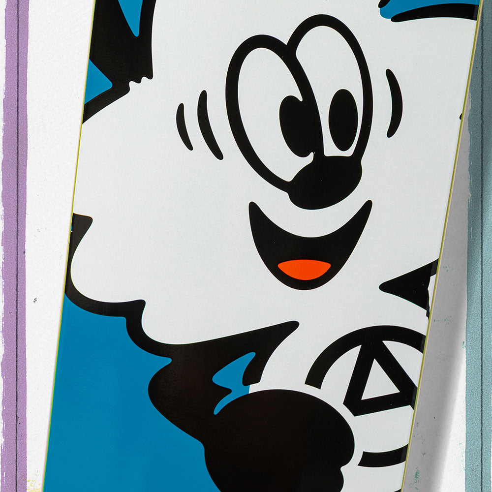 The Verdy Ishod 8.25 Real Skateboard Deck Skateshop Day features a vibrant cartoon character with wide eyes, big smile, and red tongue on a blue and white background—ideal for fans celebrating skate culture.
