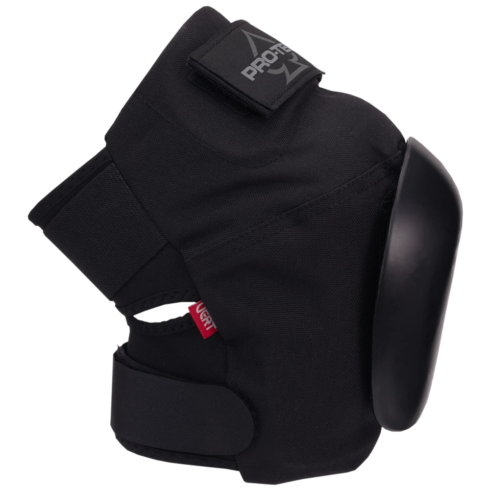 The Vert Knee Pads Protec Black feature a hard plastic shell, adjustable elastic straps, reinforced stitching, a flexible hinge design, and a small red side tag—ideal for skateboarding sports or safety use.
