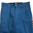 The WPSK67AF Airforce Blue Dickies Skateboarding Pant is shown from waist to mid-thigh, displaying belt loops, a metal button, zipper fly, right-side tags, and durable twill fabric with a slightly shiny finish in Regular Fit.