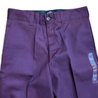 A close-up of the WPSK67MR Maroon Dickies Skateboarding Pant Regular Fit Twill, featuring belt loops, button and zipper closure, and a blue and orange waistband tag.