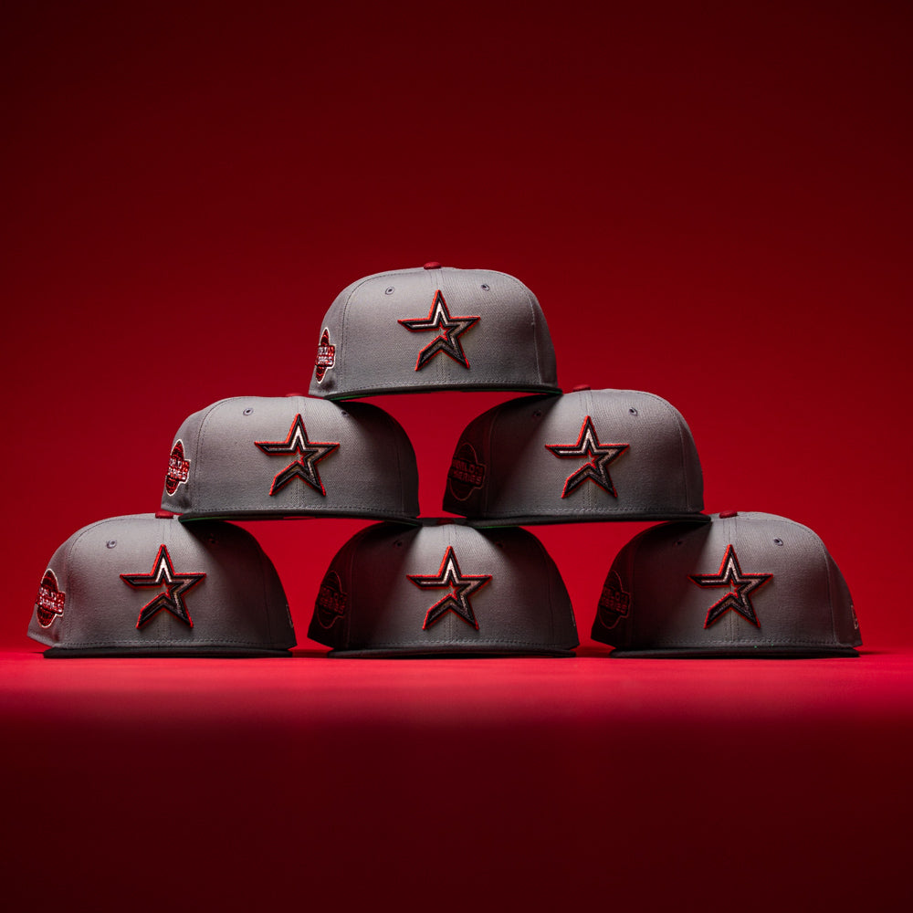 Six Days B4 WS05 Misty Black Houston Astros New Era Hat 5950 Fitted caps are arranged in a pyramid shape against a misty black and red background.