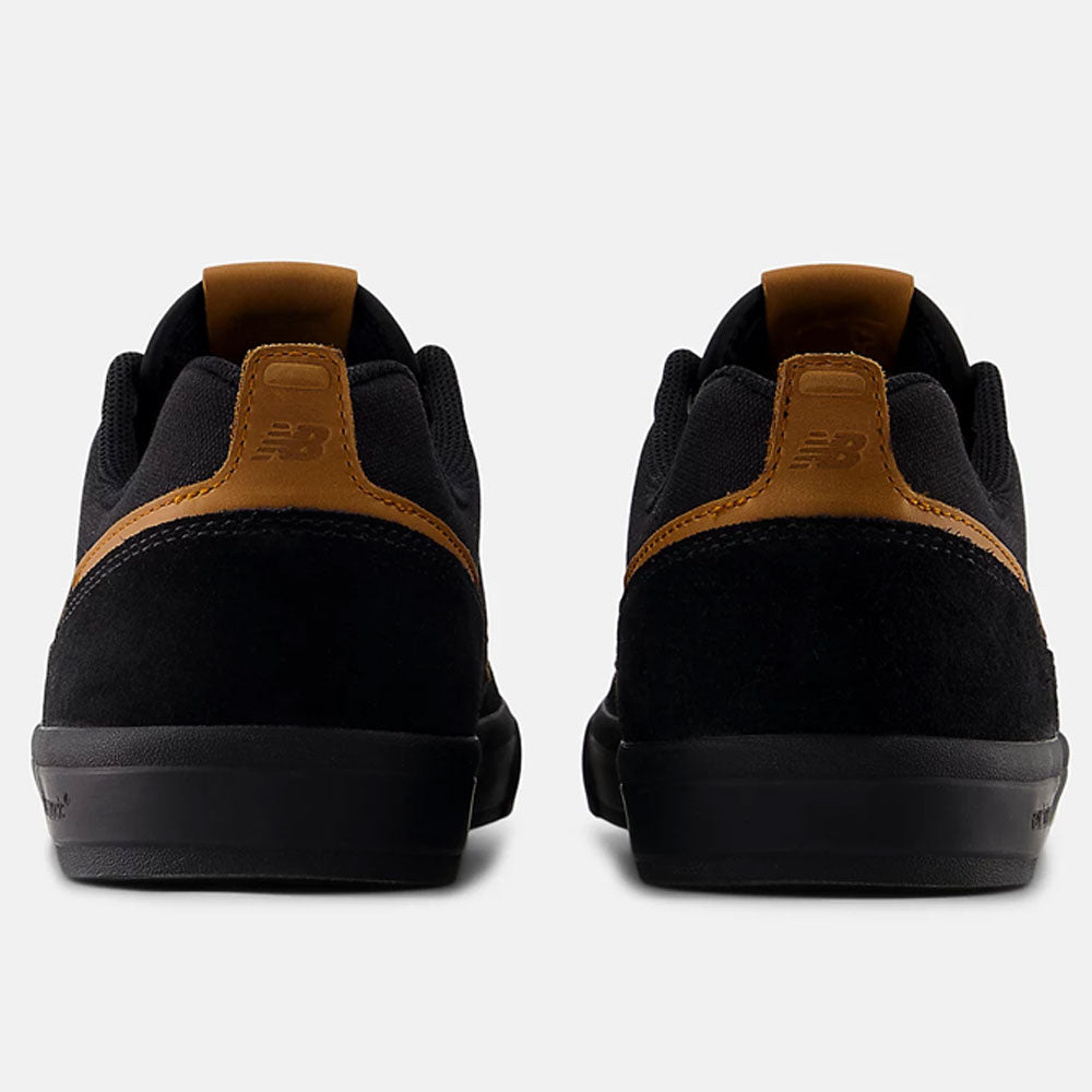 The White Black 306 BON New Balance Numeric Suede Skateboarding Shoes are shown from the back, highlighting brown suede accents and pull tabs, displayed against a white background.